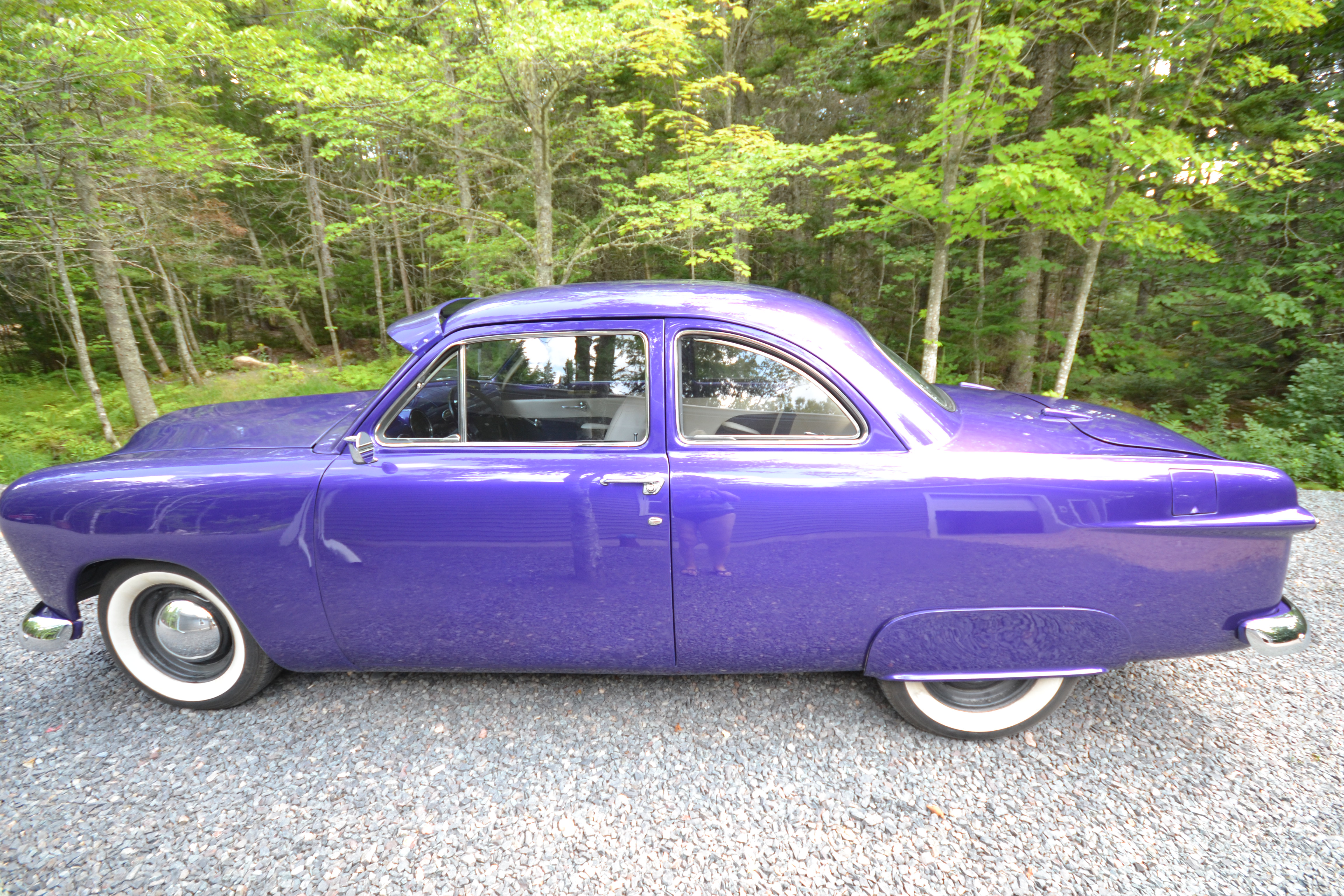 Left side profile of the purple 1950 Ford Coupe