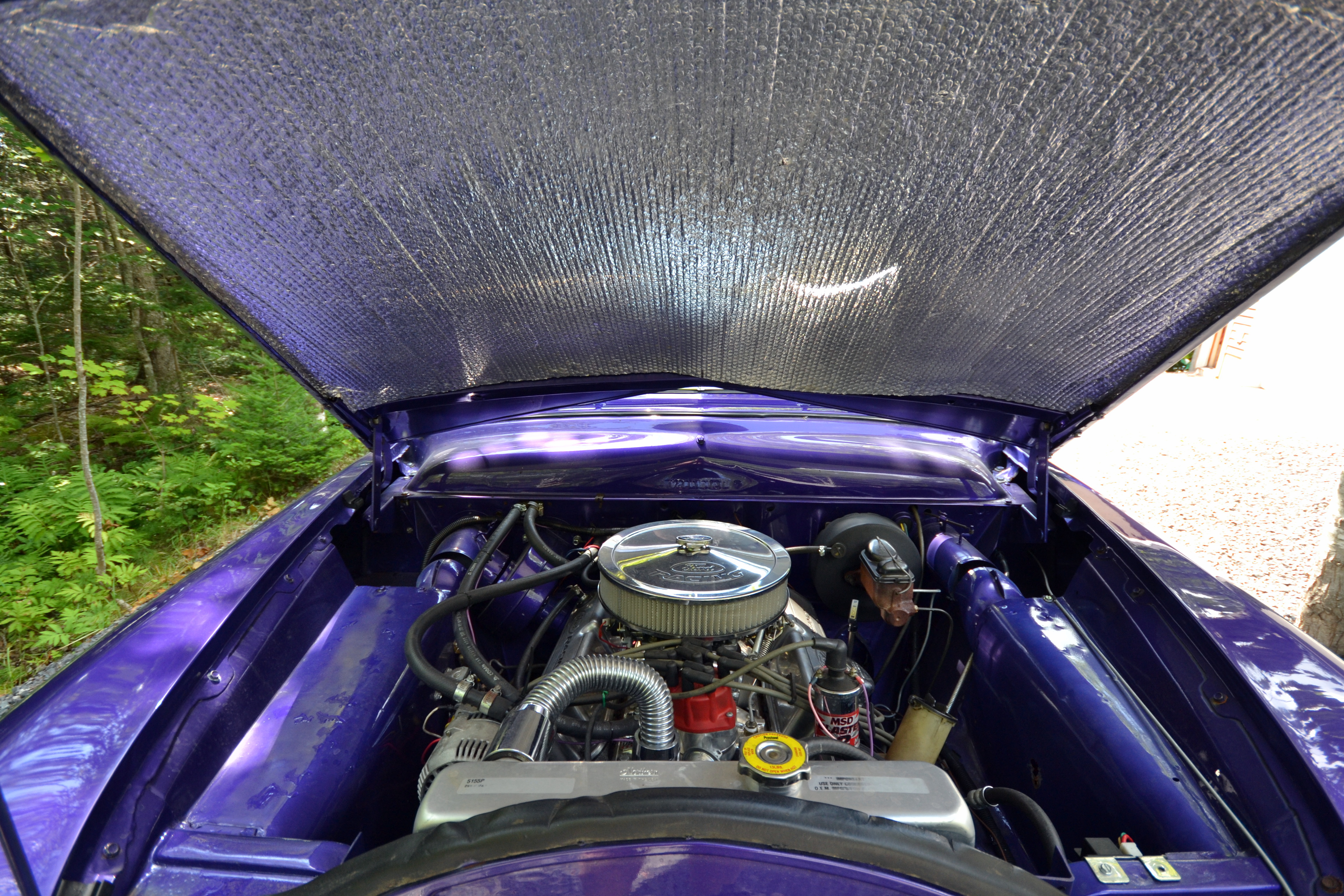 Front engine of the purple 1950 Ford Coupe, featuring a rebuilt 302 cubic inch motor and an ElderBrok 4-barrel carburetor