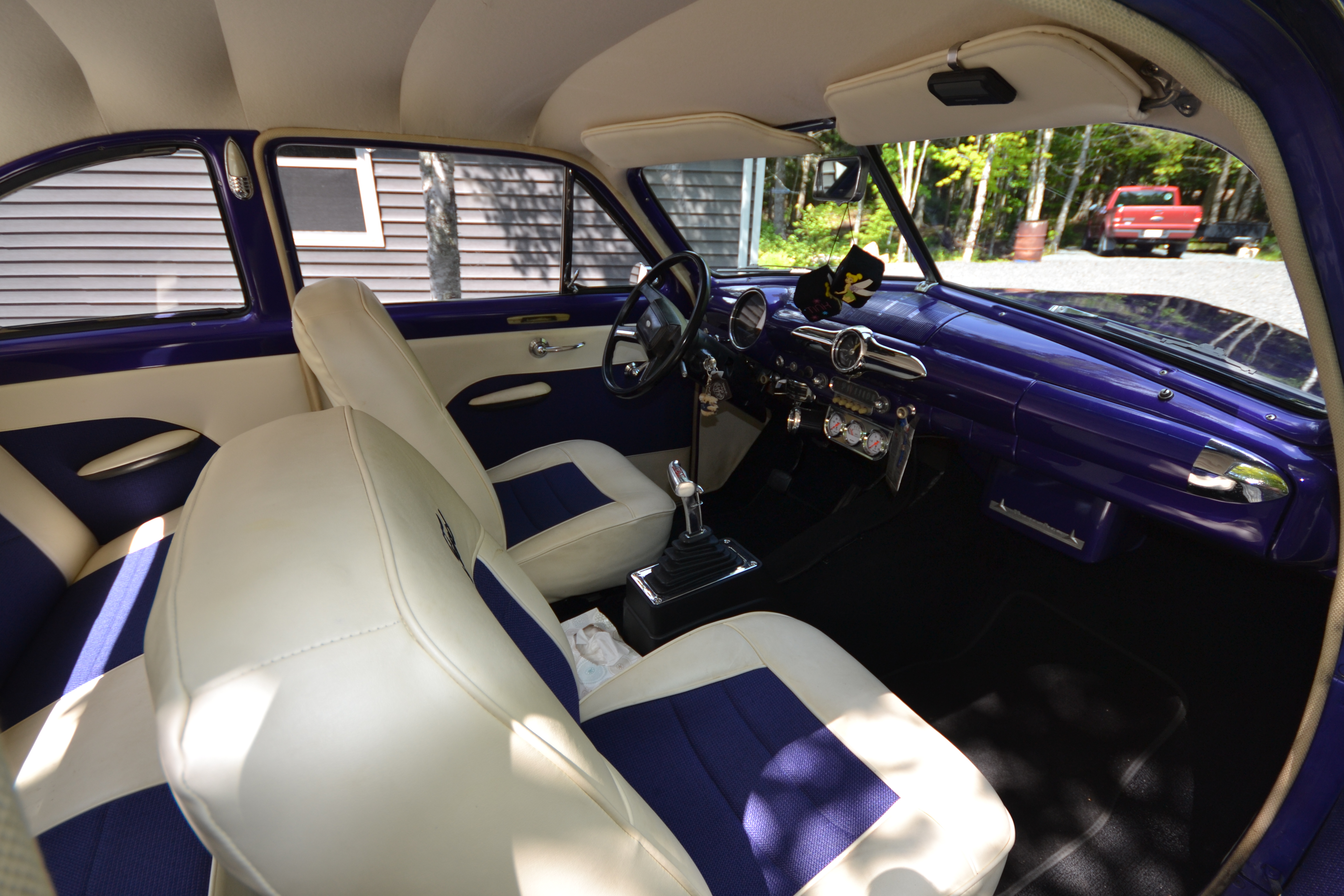 Right side profile of the purple 1950 Ford Coupe